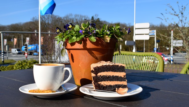 Enjoy a delicious cup of coffee with a piece of cake on our sunny terrace